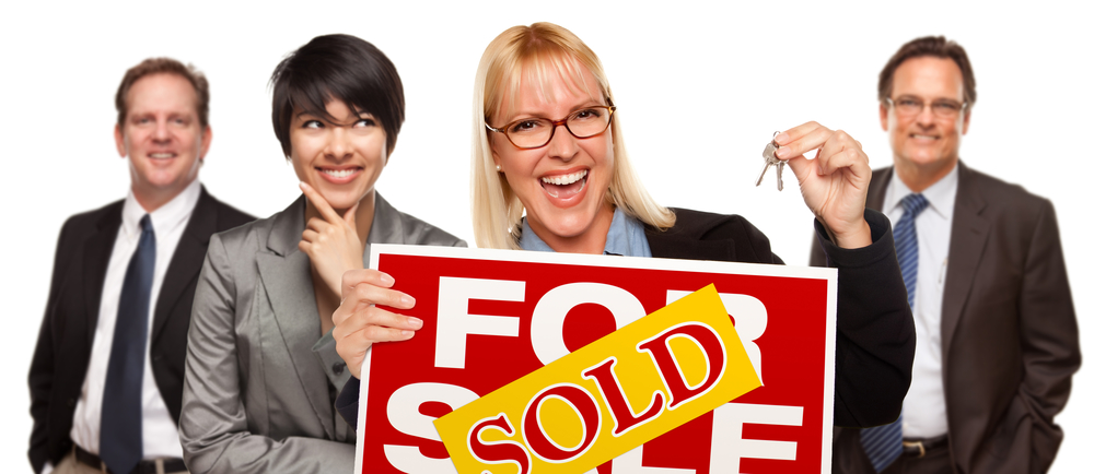 Woman Holding Keys and Sold Sign